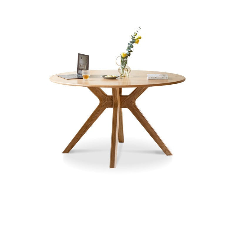 Round Nordic oak dining table with rock slab surface"